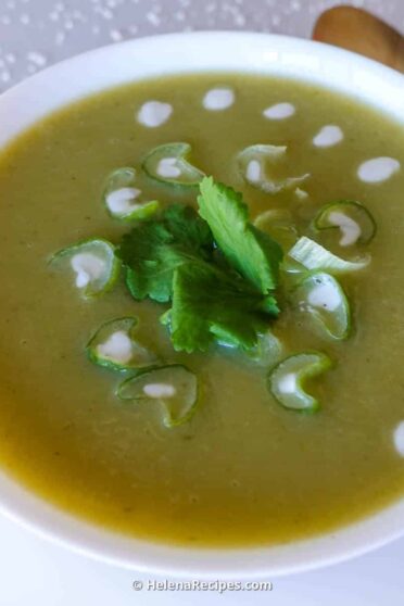 Potato leek soup in a bowl on a wooden board