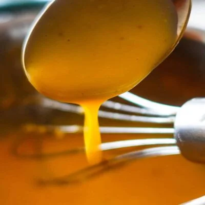 Hollandaise Sauce in a spoon.