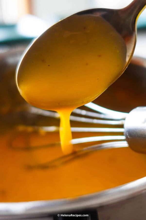 Hollandaise Sauce in a spoon.