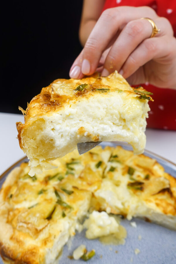 A piece of camambert quiche on a plate.