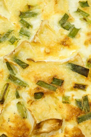 A closeup of camambert quiche in a form