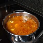 Step 5. Add water, paste and garlic
