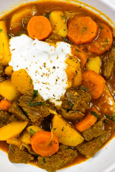 A bowl of flavorful mediterranean beef carrot potato stew on a white table