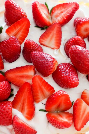 A photo of decorated Strawberry Pavlova on a glass plate