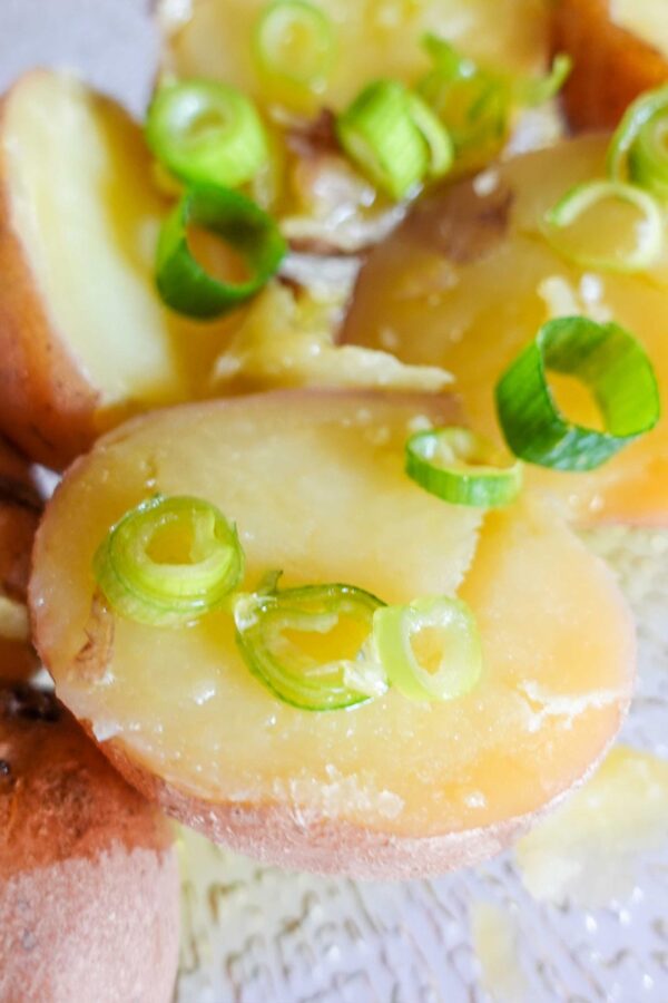Simple Boiled Red Potatoes on a plate with spring onion