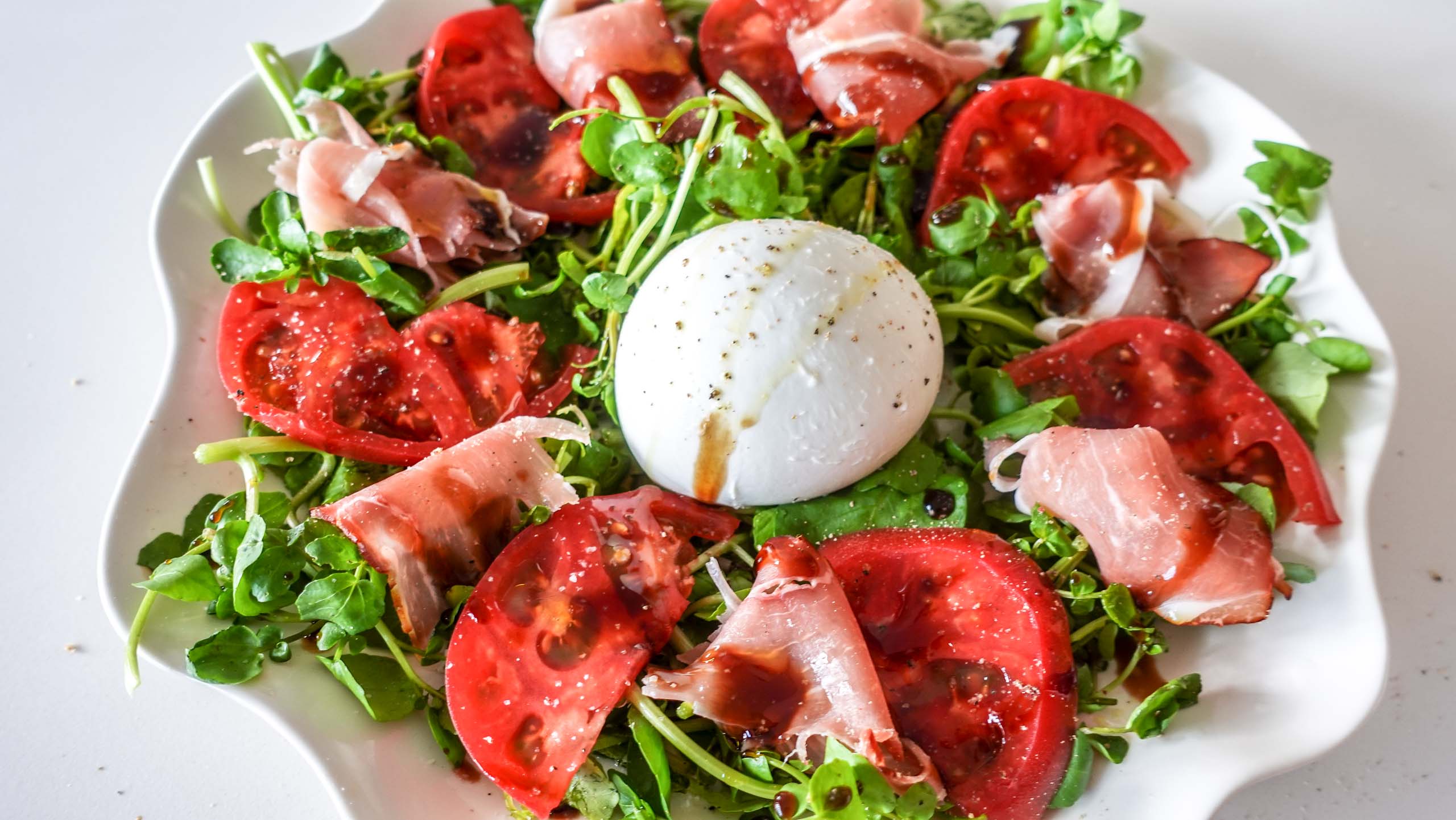 Delicious Watercress Tomato Salad on a table.