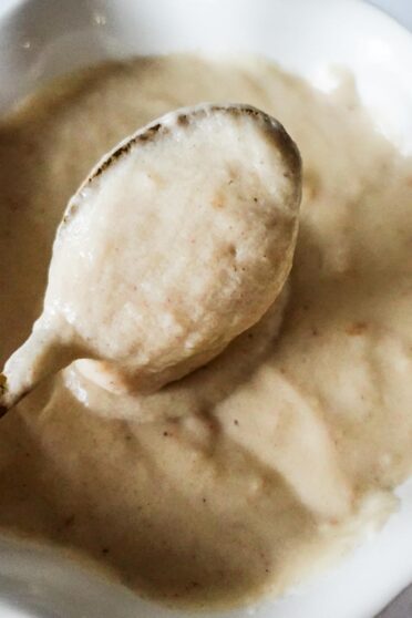 Bechamel Sauce in a bowl with spoon