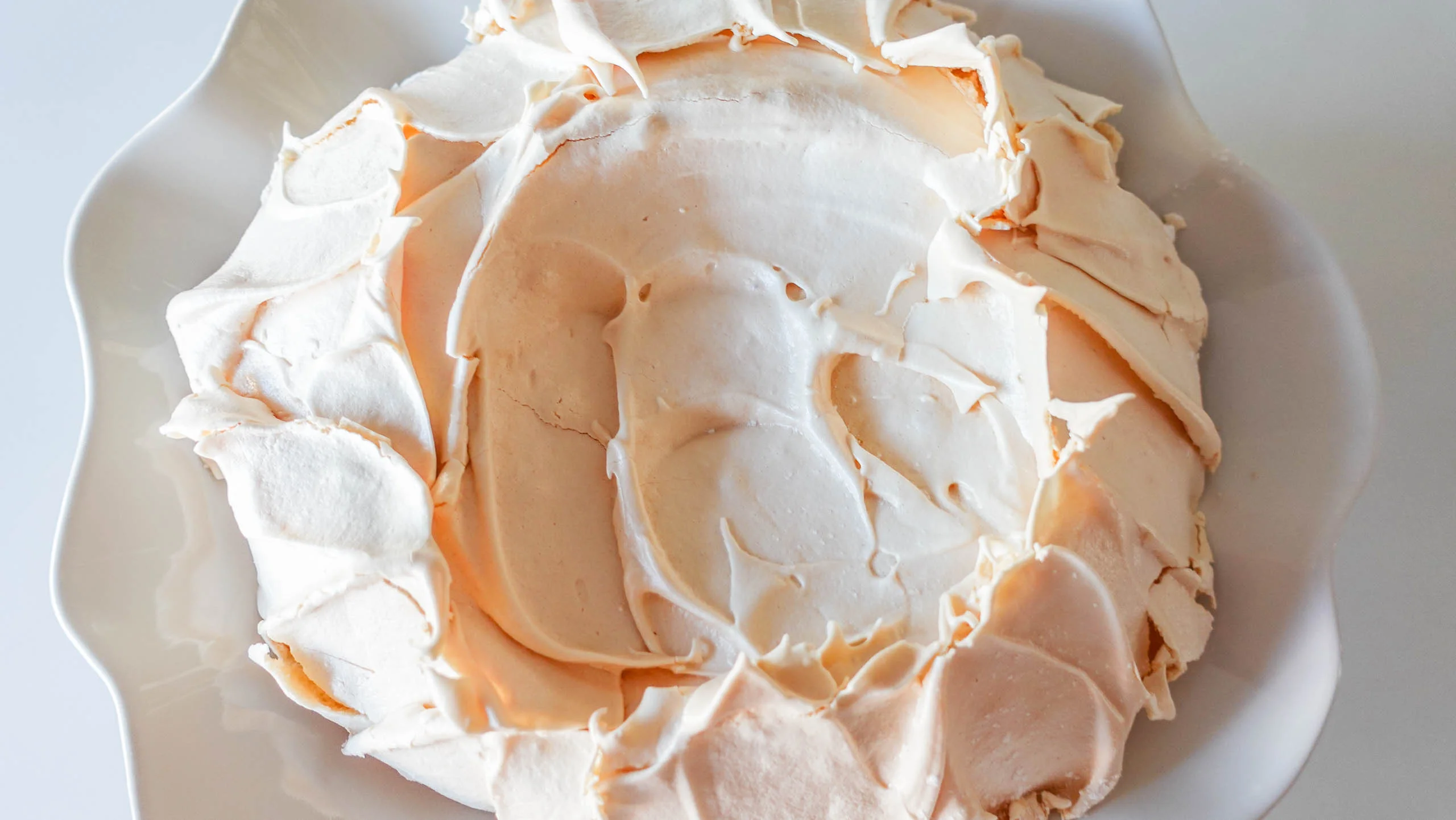 Ready pavlova shell meringue on a white plate