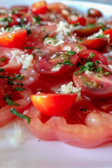 Delicious garlic tomato salad on a plate