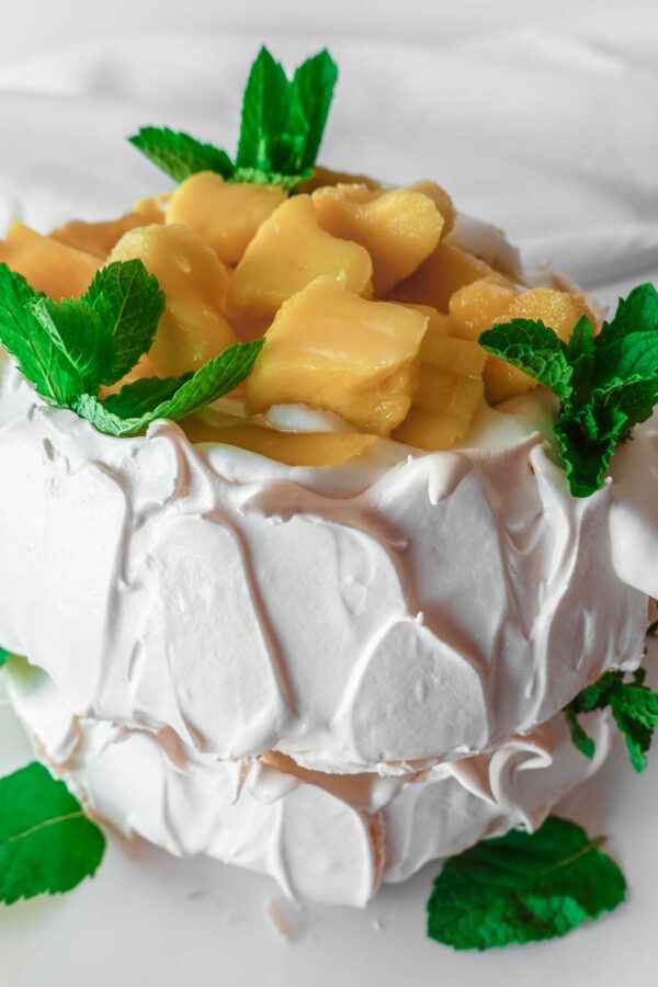 Mango Pavlova on a white plate
