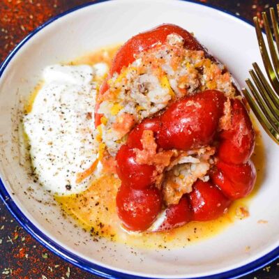 Stuffed Peppers with Ground Beef and Rice Recipe in a bowl with yogurt.