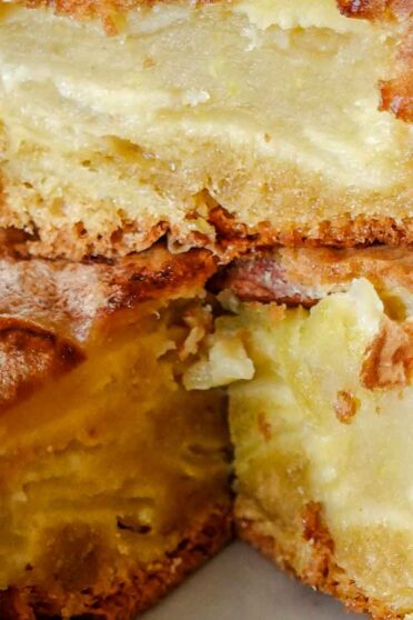 Apple Cinnamon cake on a plate with a cinnamon stick on top.