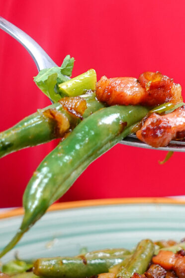 Juicy French Green Beans with Bacon on Helena's fork in one hand