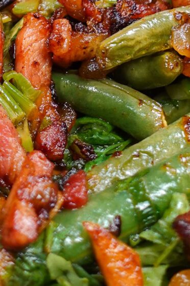 Juicy French Green Beans with Bacon on a plate with a fork