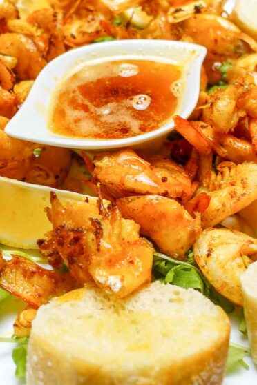 Garlic Butter Shrimp on a plate with bread toasts.