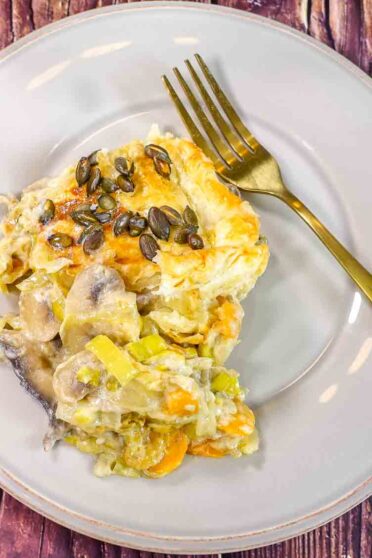 Baked leek and mushroom pie on a plate.
