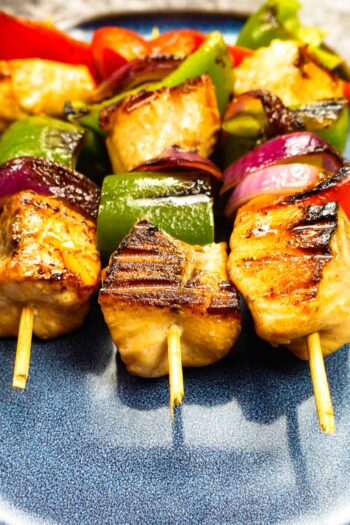 Mouthwatering salmon kabobs on blue plate