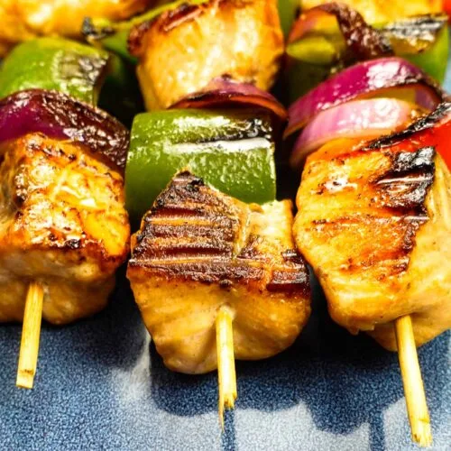 Mouthwatering salmon kabobs on blue plate