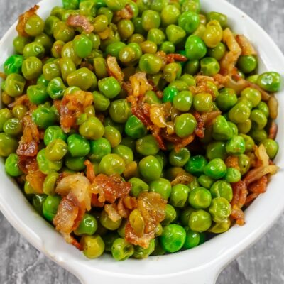 Mediterranean Peas with Bacon in a white bowl.