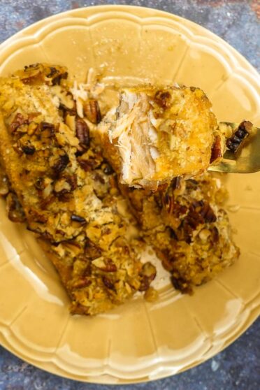 A closeup of delicious Pecan Crusted Salmon on a yellow plate.