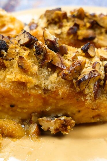 A closeup of delicious Pecan Crusted Salmon on a yellow plate.