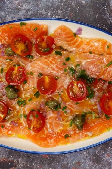 Fresh Salmon Carpaccio on a plate with a small spoon.