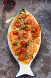 Mouthwatering salmon on a plate with a spoon.