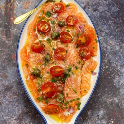 Mouthwatering salmon on a plate with a spoon.