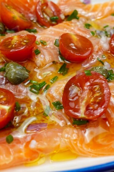 Delicious Salmon Carpaccio on a plate with a small spoon.