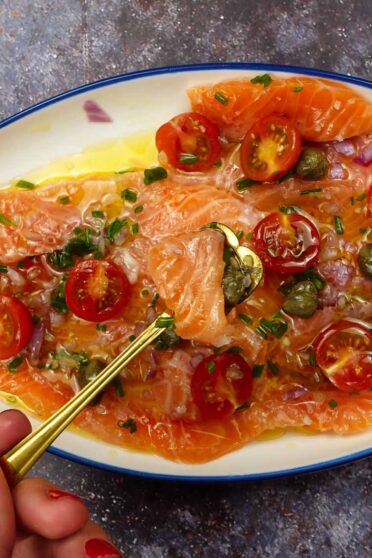 Fresh carpaccio on a plate with a small spoon