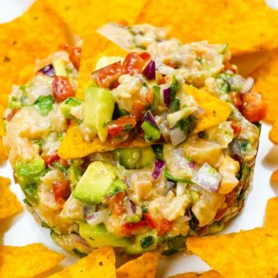 Spicy Salmon Tartare with Corn Chips on a white plate.