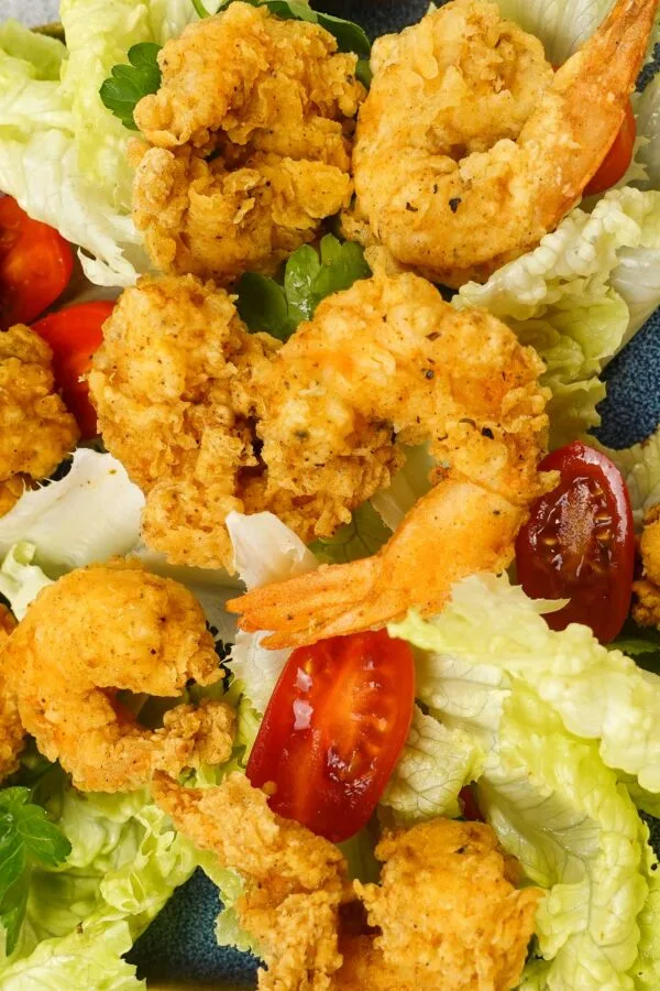 Crispy fried shrimp served on fresh lettuce with cherry tomatoes.
