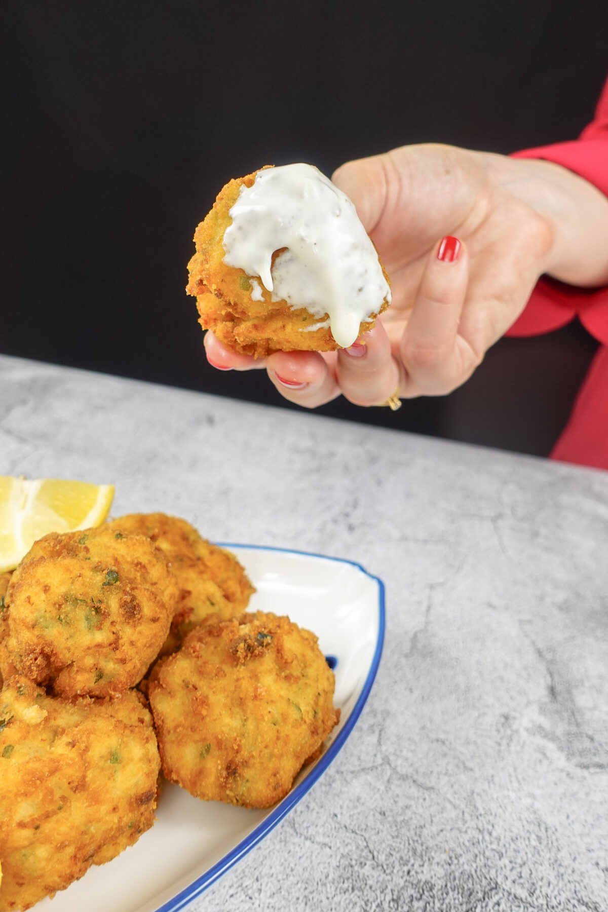 Mediterranean Shrimp Croquette dipped in a sauce.