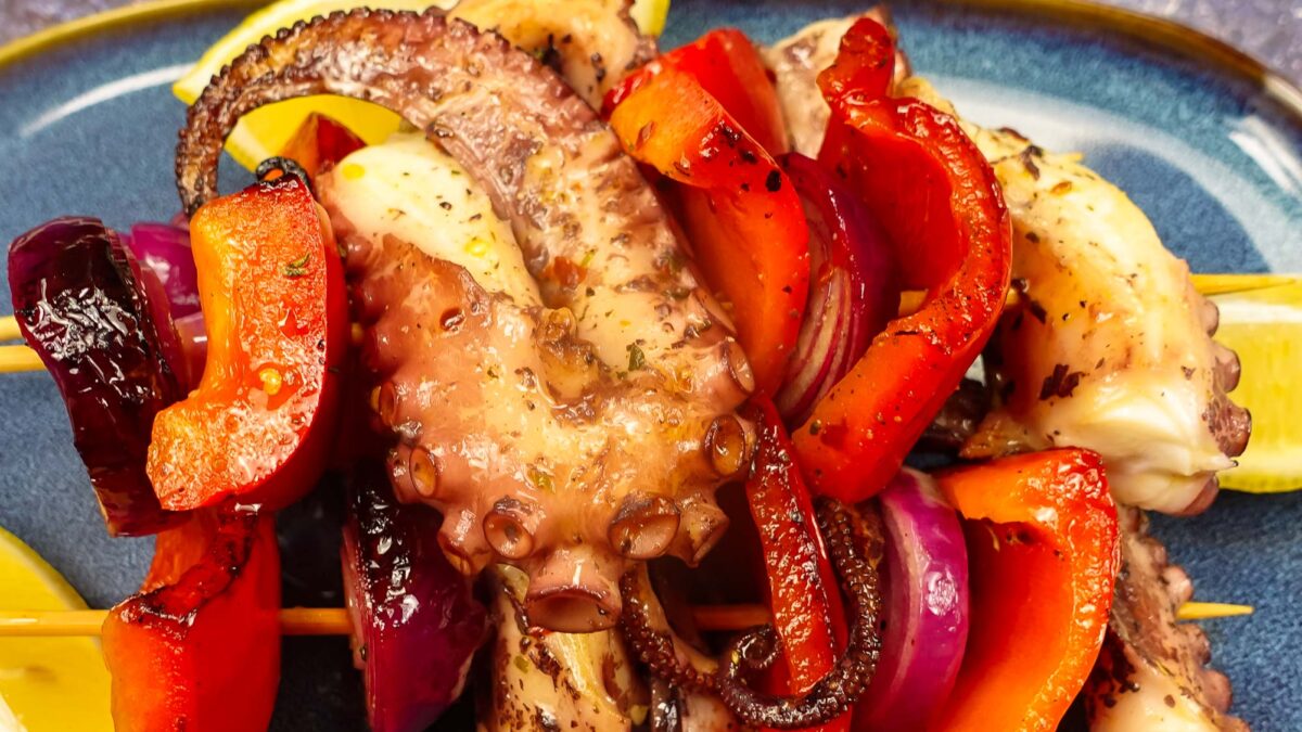 Grilled Octopus Skewers on a blue plate.