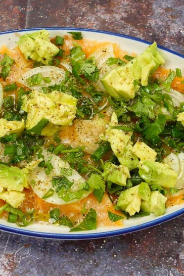 Delicious Salmon Carpaccio with Avocado in a beautiful plate.