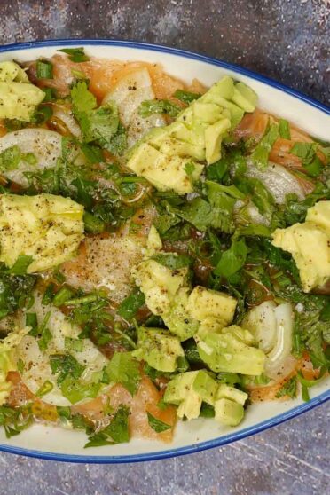 Healthy Avocado Salmon Carpaccio on a plate.