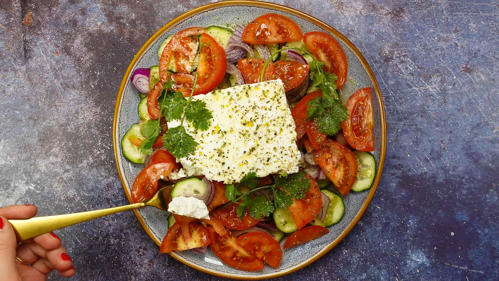 Juicy and delicious Tomato Cucumber Feta Salad on a plate.