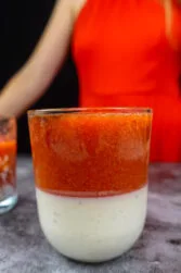 Panna Cotta with Strawberry Compote in a glass with Helena standing behind