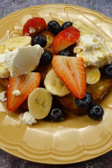 Cinnamon French Toast on a yellow plate in two hands