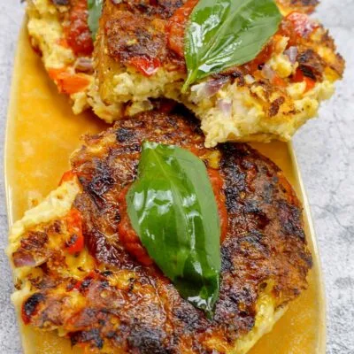 Juicy and mouthwatering Fried shrimp bagel on a plate with fresh basil