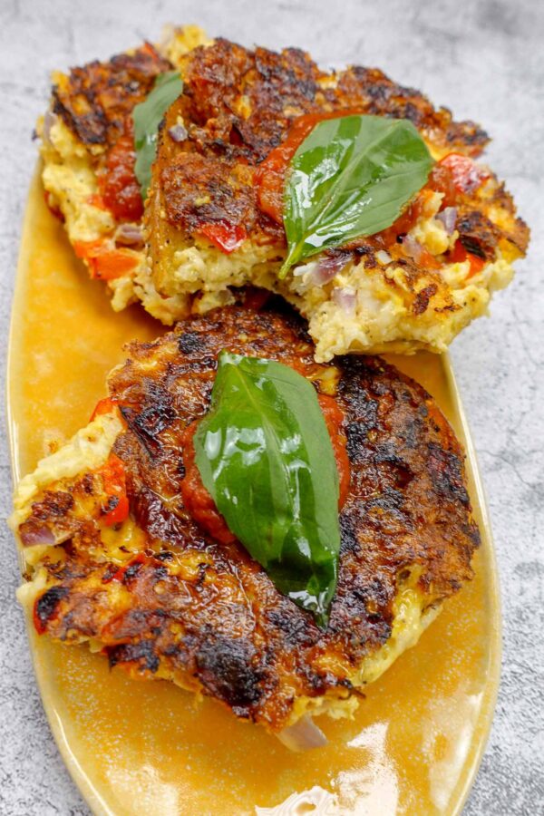 Juicy and mouthwatering Fried shrimp bagel on a plate with fresh basil