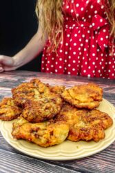 Helena is standing next to a plate with breaded beef steak