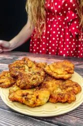 Helena is standing next to a plate with breaded beef steak