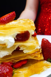 Helena is standing behind strawberry napoleons