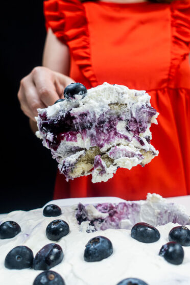 A big portion of blueberry tiramisu in Helena's right hand