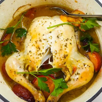 A dutch oven whole roast chicken with plums