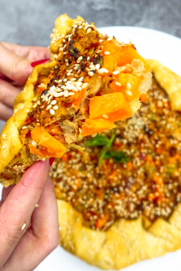 Gourmet Tuna Quiche Piece in two hands
