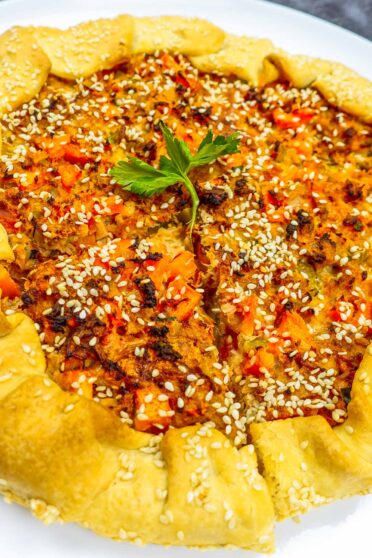 Freshly baked tuna quiche on a white plate