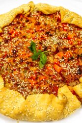 Whole baked tuna quiche on a white plate