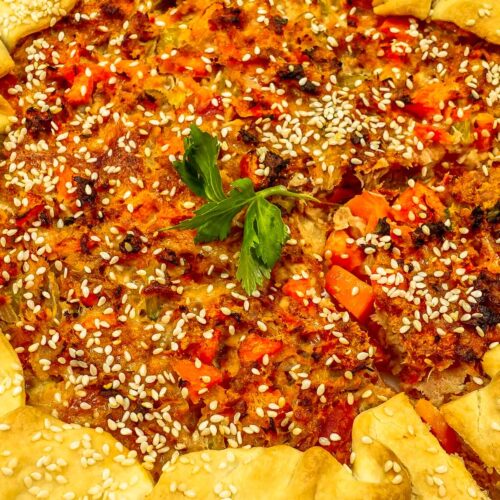 Whole baked tuna quiche on a white plate